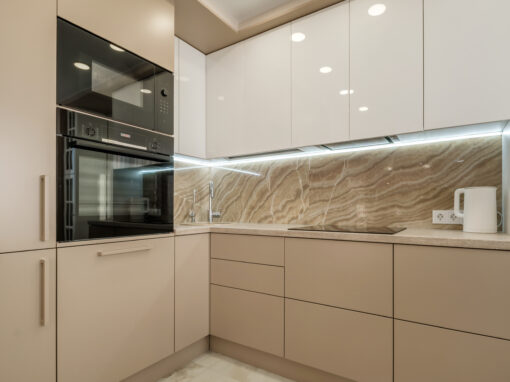 Cocina moderna con frentes en crema y encimera de mármol